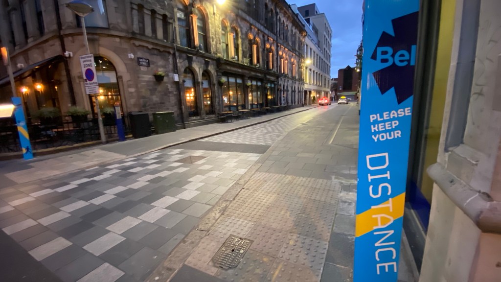 This is a photo of a poster informing to keep distance between people during the COVID-19 pandemic in Belfast, Northern Ireland.