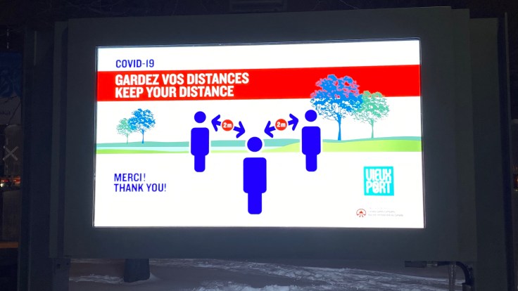 This is a photo of a poster informing to keep distance between people during the COVID-19 pandemic in the Old Port of Montreal, Canada.
