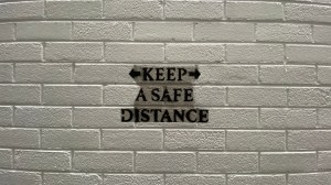 Graffiti text of Covid-19 "keep a safe distance" during Lockdown 3 in Belfast, Northern Ireland