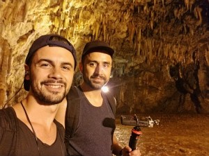 Photo of two sound artists in a cave with sound recorders